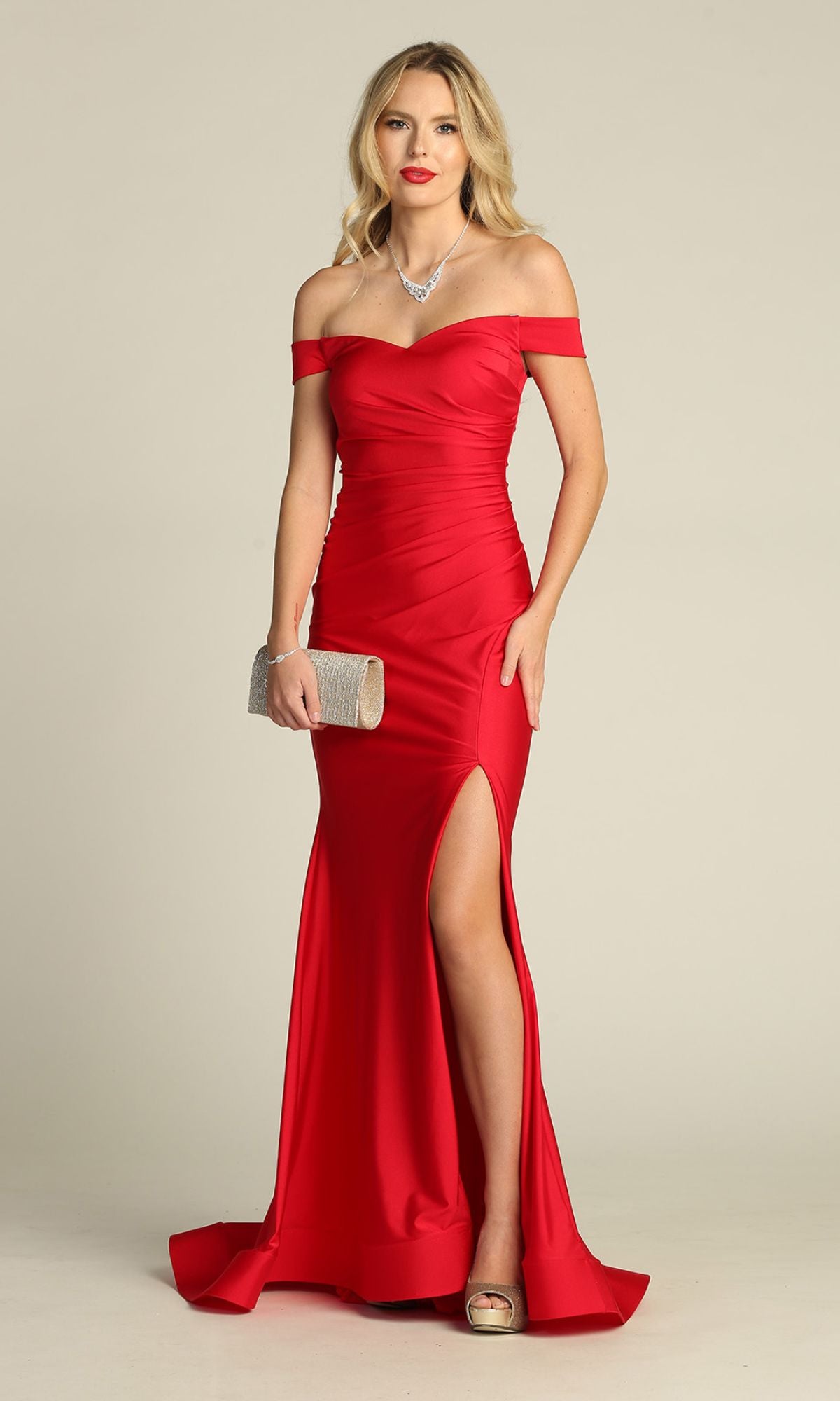 A woman models the Chicas YG5025 off-the-shoulder long prom dress in red, featuring a thigh-high slit, as she holds a silver clutch against a neutral background.